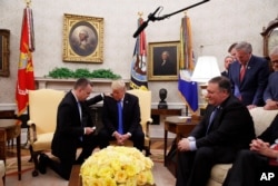 FILE - President Donald Trump prays with American pastor Andrew Brunson in the Oval Office of the White House, Oct. 13, 2018.