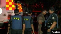 FILE - Members of the Rapid Action Battalion are seen deployed in respoonse to a hostage situation in the upscale Gulshan area of Dhaka, Bangladesh, July 2, 2016.