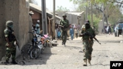 Nigerian soldiers are seen patrolling a town in Borno state, April 30, 2013.