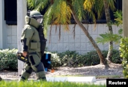 A member of the Broward County Sheriff&#39;s Office bomb squad walks to the building where U.S. Rep. Debbie Wasserman Schultz&#39;s office is housed in Sunrise, Florida, Oct. 24, 2018.