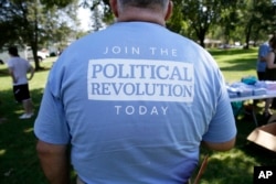 Seen is the back of a shirt on a supporter for Democratic presidential candidate, Sen. Bernie Sanders, I-Vt., during a town hall meeting, Sept. 3, 2015, in Grinnell, Iowa.