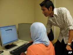 Nyein Kyaoo helps his students learn computer skills as well as the differences between Burmese and US society.