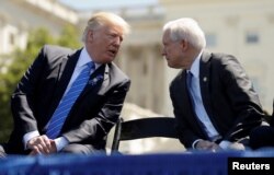 FILE - President Donald Trump speaks with Attorney General Jeff Sessions as they attend the National Peace Officers Memorial service on the West Lawn of the U.S. Capitol in Washington, May 15, 2017.
