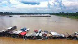 FILE - Dredging barges operated by illegal miners converge on the Madeira river, a tributary of the Amazon River, searching for gold, in Autazes, Amazonas state, Brazil, Nov. 25, 2021.