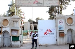 FILE - Christopher Stokes, the general director of medical charity Doctors Without Borders, stands at the gate of the organization's hospital, after it was hit by a U.S. airstrike, in Kunduz, Afghanistan, Oct. 15, 2015.
