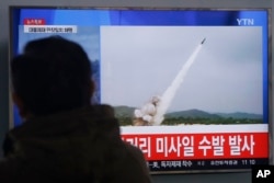 FILE - A man watches a TV news program showing file footage of missile launch conducted by North Korea, at Seoul Railway Station in Seoul, South Korea, March 3, 2016.