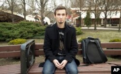 In this image made from video taken March 27, 2019, university student Maxim Kaluga, 21, speaks to the Associated Press in Donetsk, Ukraine.