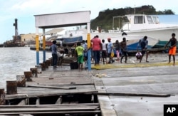 People recover broken parts of the dock after the passing of Hurricane Irma, in St. John's, Antigua and Barbuda, Sept. 6, 2017. Heavy rain and 185-mph (295 kph) winds lashed the Virgin Islands and Puerto Rico's northeast coast from Irma, the strongest Atlantic hurricane on record.