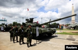 FILE - Members of Nicaragua's Army stand next to Russian-made T-72B Tank in Managua, Nicaragua, Aug. 12, 2017.