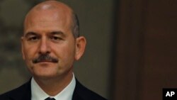 Suleyman Soylu, Turkey's interior minister, listens to President Recep Tayyip Erdogan during a news conference in Ankara, Turkey, July 9, 2018.