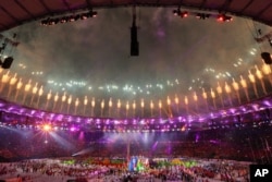 Samba dancers perform as fireworks go off during the closing ceremony in the Maracana stadium at the 2016 Summer Olympics in Rio de Janeiro, Brazil, Sunday, Aug. 21, 2016.