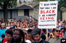 Hundreds gather at the JJ Hill Montesorri School Thursday, July 7, 2016, in St. Paul, Minn. for a vigil following the shooting death by police of Philando Castile.