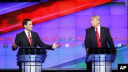presidential candidate, businessman Donald Trump listens, during the Republican presidential debate sponsored by CNN, Salem Media Group and the Washington Times at the University of Miami, Thursday, March 10, 2016.