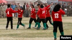 FILE - The Afghan national women's soccer team celebrates a victory in a friendly match against a women's team from the NATO-led International Security Assistance Force in Kabul, Oct. 29, 2010.