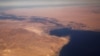 FILE - The Suez Canal connecting the Mediterranean Sea to the Red Sea is pictured from the window of a commercial plane flying over Egypt.