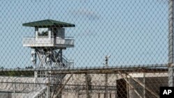 FILE - A guard tower stands above a maximum security prison in South Carolina.