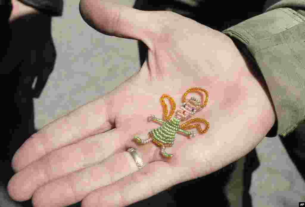 A Ukrainian army soldier holds an amulet given to him by an unknown child, Debaltsevo, Donetsk's region, Ukraine,&nbsp;Sept. 18, 2014. 
