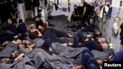 FILE - Foreign prisoners, suspected of being part of the Islamic State, lie in a prison cell in Hasaka, Syria, Jan. 7, 2020. 