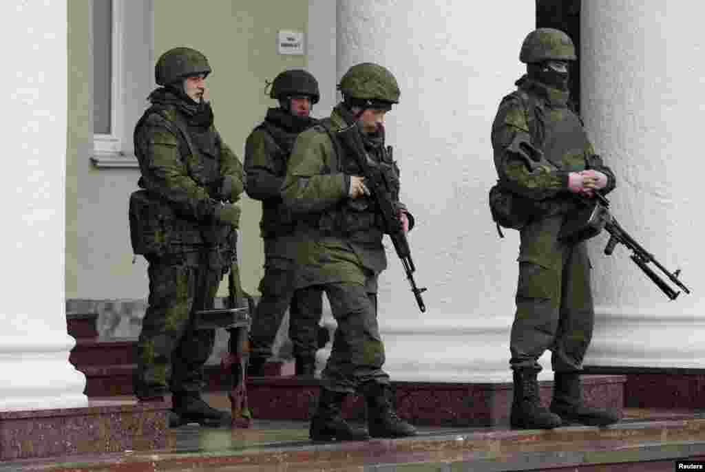Armed men stand guard at the Simferopol airport in the Crimea region of Ukraine, Feb. 28, 2014. 
