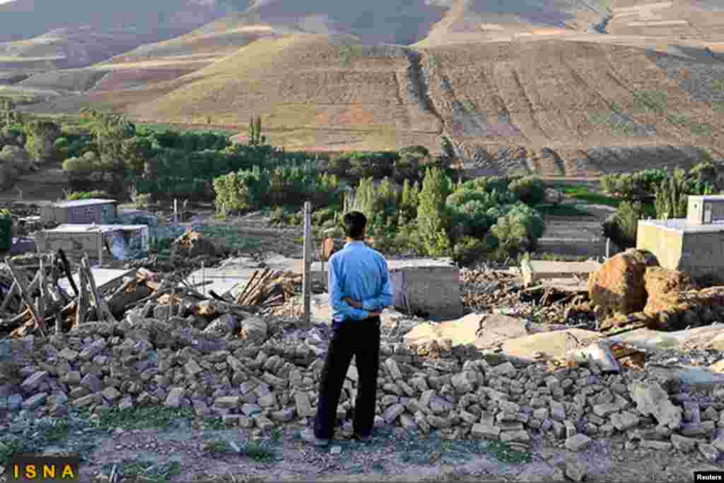 A man looks at damaged houses in the earthquake-stricken village of Varzaqan near Ahar, in East Azerbaijan province, August 12, 2012.