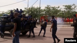 FILE - Riot policemen fire tear-gas canisters to disperse supporters of Congolese opposition presidential candidate Martin Fayulu as they welcome him at N'djili International Airport in Kinshasa, Democratic Republic of Congo, Nov. 21, 2018.