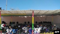 This handout photo taken and released Dec. 5, 2019, by the International Organization for Migration (IOM) shows survivors of the Dec. 4, 2019, shipwreck off the coast of Mauritania.
