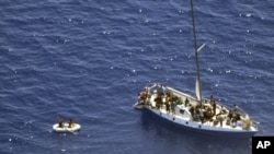 Illegal immigrants are seen on a sailboat near island of Mljet, southern Croatia, Monday, July 2, 2012.