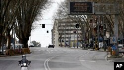 Writing on an electronic board at top right reads in Italian "Emergency Coronavirus limit you movements" above a street in Rome, in Rome, March 18, 2020.