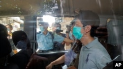 FILE - Ted Hui, a former lawmaker in Hong Kong’s Legislative Council, is arrested by police in Hong Kong, Aug. 26, 2020. On Monday, Hong Kong police issued arrest warrants for him and seven other self-exiled pro-democracy activists, charging them with national security offenses.