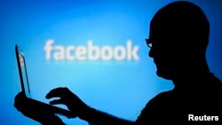 A Turkish soldier holds a lost baby as he looks for the mother, as thousands of new Syrian refugees from Kobani arrive at the Turkey-Syria border crossing of Yumurtalik near Suruc, Turkey.