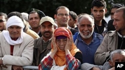 People at a ceremony marking the first anniversary of the Tunisian Revolution December 17, 2011, in the town of Sidi Bouzid, where it was sparked by the self-immolation of a fruit vendor.