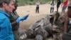 U.S. Secretary of the Interior Sally Jewell talks with investigators near the carcass of a poached rhino in Kruger National Park, South Africa’s biggest wildlife reserve, Jan. 29, 2016. 