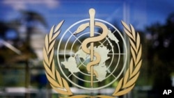 FILE - The World Health Organization logo is seen at its Geneva headquarters. The WHO has reported a one-day record high in coronavirus cases worldwide, with more than 350,000 cases reported to the U.N. health agency on Oct. 9, 2020.