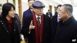 Wu Dawei, center, China's special representative for Korean Peninsula Affairs, is greeted by Pak Song Il, right, deputy director of the America department at the North Korean Foreign Ministry, upon arrival in Pyongyang, Feb. 2, 2016. 