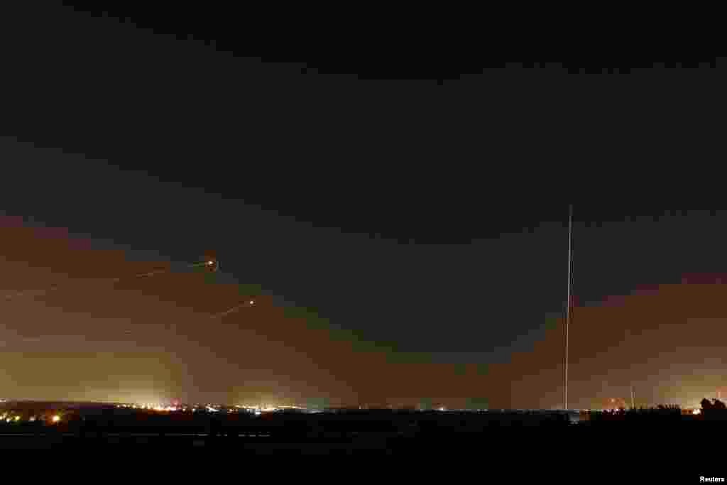 Rockets launched from the Gaza Strip towards Israel&nbsp; (at right) as a rocket by the Iron Dome anti-missile system (at left) is fired to intercept them, before a five-day ceasefire was due to expire, Aug. 19, 2014.