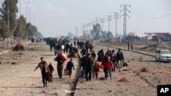 Displaced Iraqis, who fled fighting between Iraqi security forces and Islamic State militants, return to their homes in neighborhoods retaken by Iraqi government forces in the eastern side of Mosul, Iraq, Wednesday, Jan. 4, 2017. 