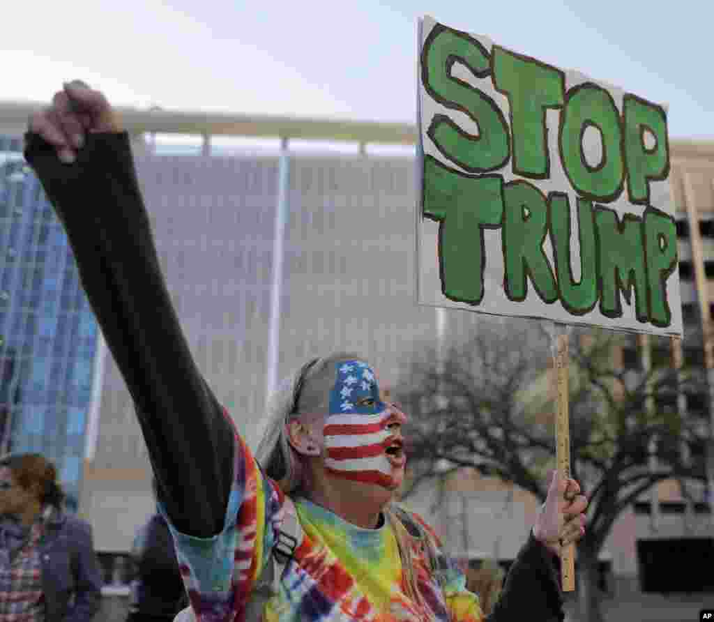Mary Johnson protests against the election of President-elect Donald Trump in front of City Hall in Kansas City, Mo., Nov. 12, 2016.
