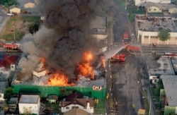 FILE - A fire burns out of control in South Central Los Angeles April 30, 1992. Hundreds of stores were burned after rioting erupted after the verdicts in the Rodney King case.