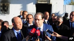 Tunisian Prime Minister Youssef Chahed speaks to reporters as he visits a sacked police station in El Battan, 35 kms west of Tunis, Jan. 10, 2018.