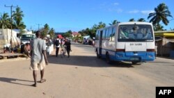 A bus drives along a street in Macomia, Cabo Delgado province, Mozambique, June 11, 2018. Cabo Delgado, expected to become the center of a natural gas industry after several promising discoveries, has seen a string of assaults on security forces and civilians since October.