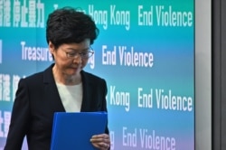 Hong Kong Chief Executive Carrie Lam leaves after a press conference in Hong Kong, Oct. 4, 2019.