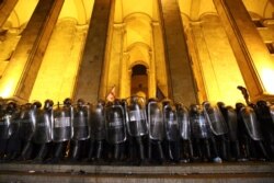 Police block an entrance of the Georgian Parliament as opposition demonstrators gather to call for the resignation of the speaker of the Georgian Parliament in Tbilisi, Georgia, June 21, 2019.