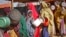 FILE - Women who fled drought queue to receive food at a camp for internally displaced persons, in the Daynile neighborhood on the outskirts of the capital Mogadishu, Somalia, May 18, 2019. 