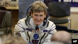 FILE - U.S. astronaut Peggy Whitson, member of the main crew of the expedition to the International Space Station, speaks with her relatives prior the launch of Soyuz MS-3 space ship at the Russian-leased Baikonur cosmodrome, Kazakhstan, Nov. 17, 2016.