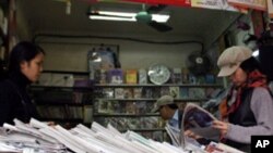 People browse through newspapers at a shop in Hanoi, Vietnam. (FILE)