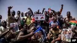 FILE - People take to the streets of Ouagadougou, Burkina Faso, Jan. 25, 2022 to rally in support of the new military junta that ousted democratically elected President Roch Marc Christian Kabore and seized control of the country. 