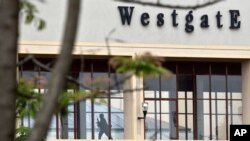 A Kenyan soldier runs through a corridor on an upper floor, shortly before an explosion was heard, at the Westgate Mall in Nairobi, Sept. 24, 2013. 