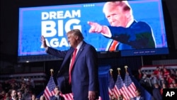 FILE - Former U.S. President Donald Trump waves at a campaign rally in Grand Rapids, Michigan, Nov. 5, 2024. Trump, who has been reelected as U.S. president, has left little question about the sort of economic policies he will pursue when he is sworn in for a second term. 