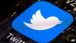 FILE - A Twitter app icon is pictured on a mobile phone. 