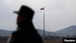 FILE - A North Korean flag flutters on top of a tower in Gijungdong, North Korea, in this picture taken near the truce village of Panmunjom.